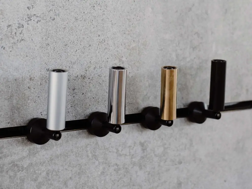 Bespoke modular LED spotlight inserts and fixtures for System 77 by OZ Lighting, shown in silver, gold, and anodized black finishes for versatile matrix configurations.